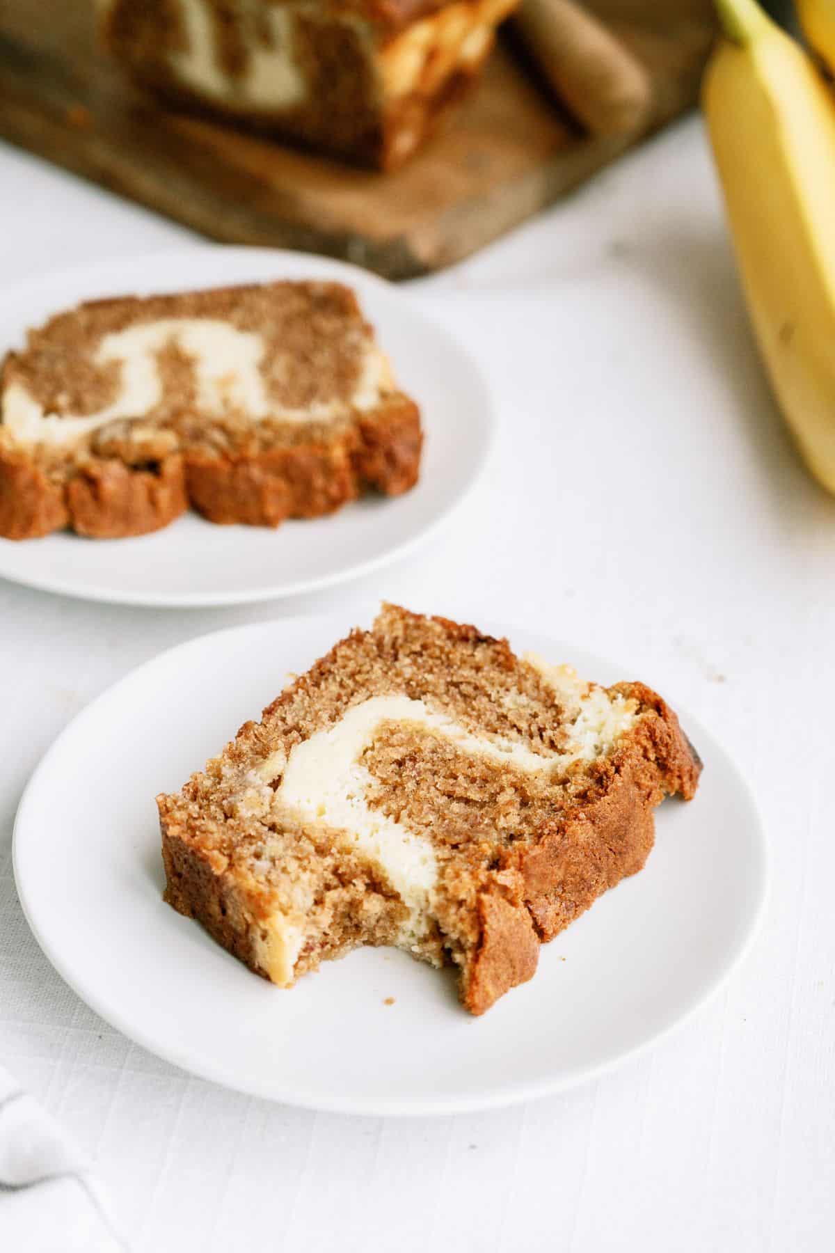 Two plates with slices of Cream Cheese Banana Bread on them