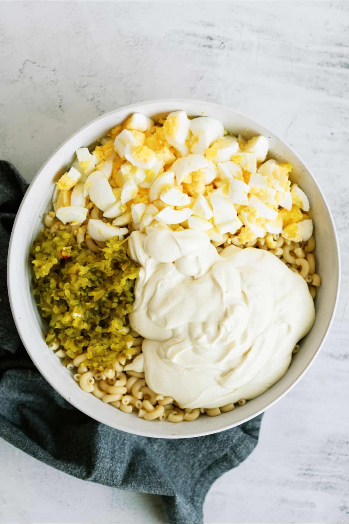 All ingredients for Deviled Egg Pasta Salad in a large mixing bowl