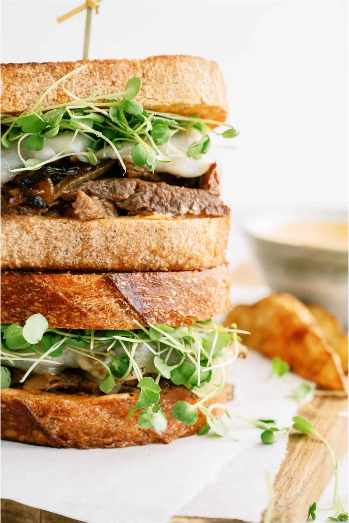 Close up of 2 Instant Pot Pot Roast Sandwiches stacked on top of each other