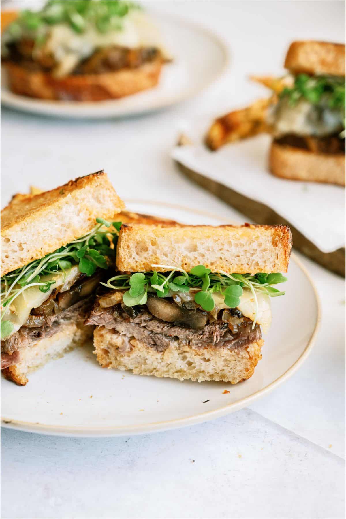 Instant Pot Pot Roast Sandwich cut in half on a plate