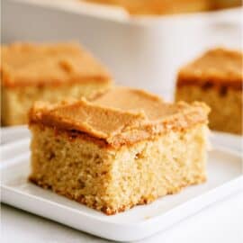 A slice of Peanut Butter Sheet Cake on a plate