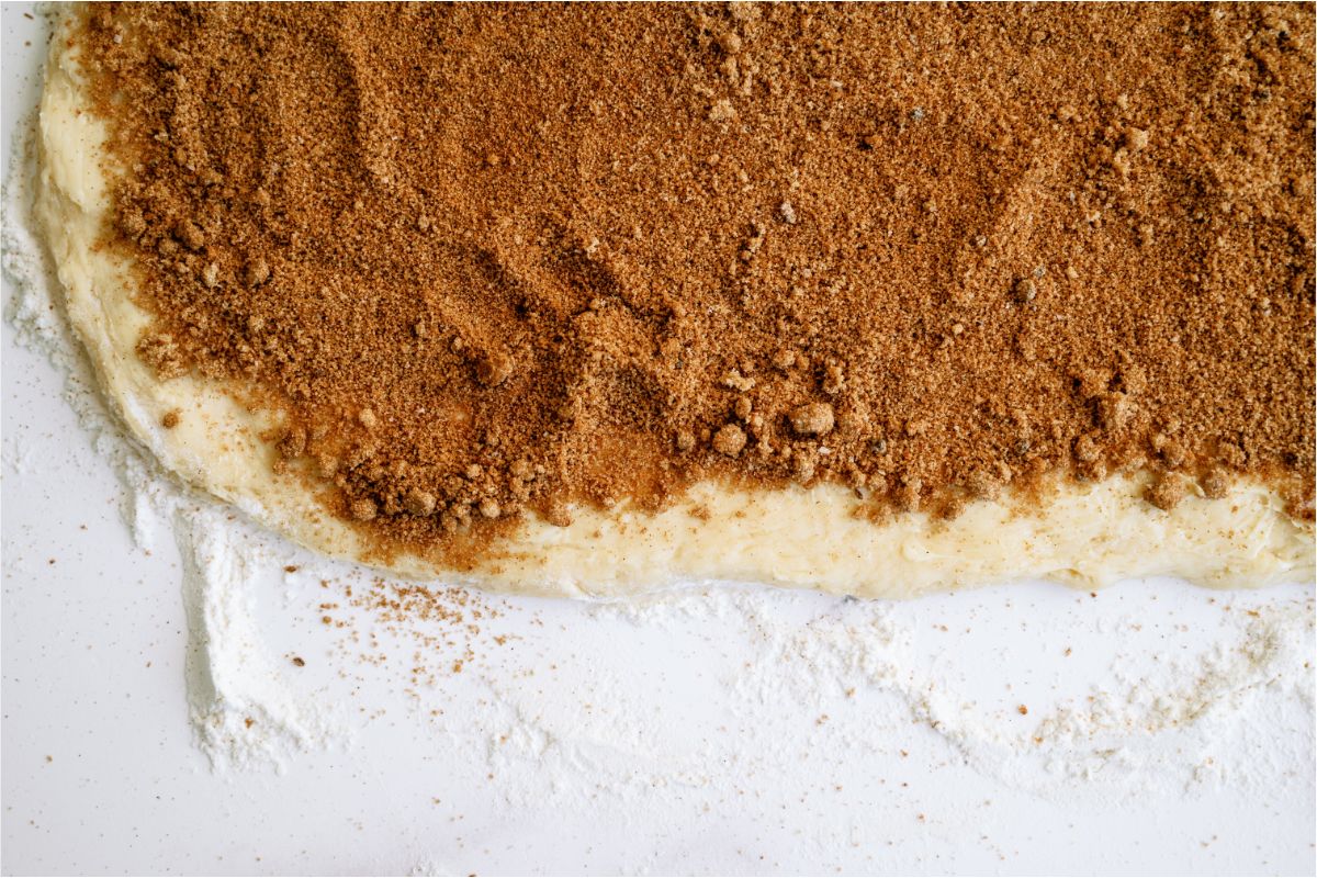 Brown sugar and cinnamon mixture spread all over rolled out dough