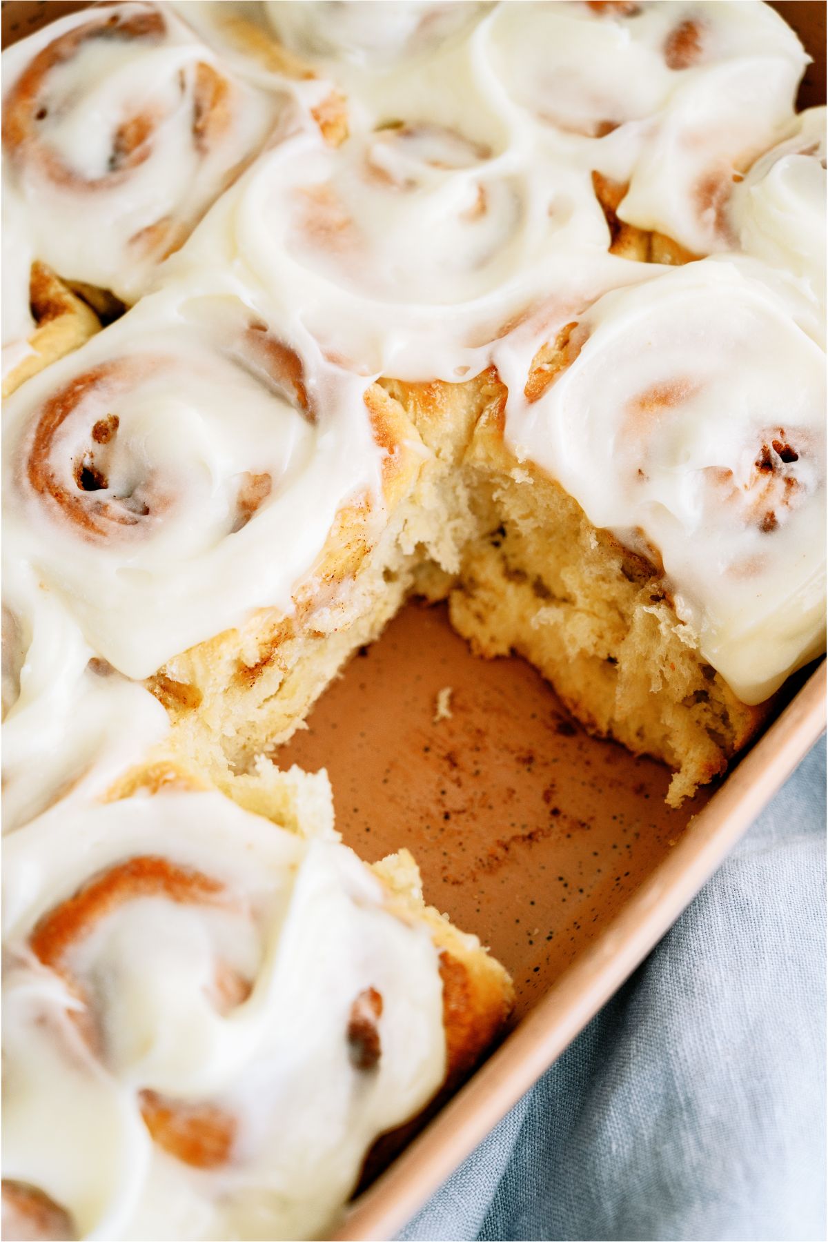 A pan of The BEST Homemade Cinnamon Rolls with one roll missing