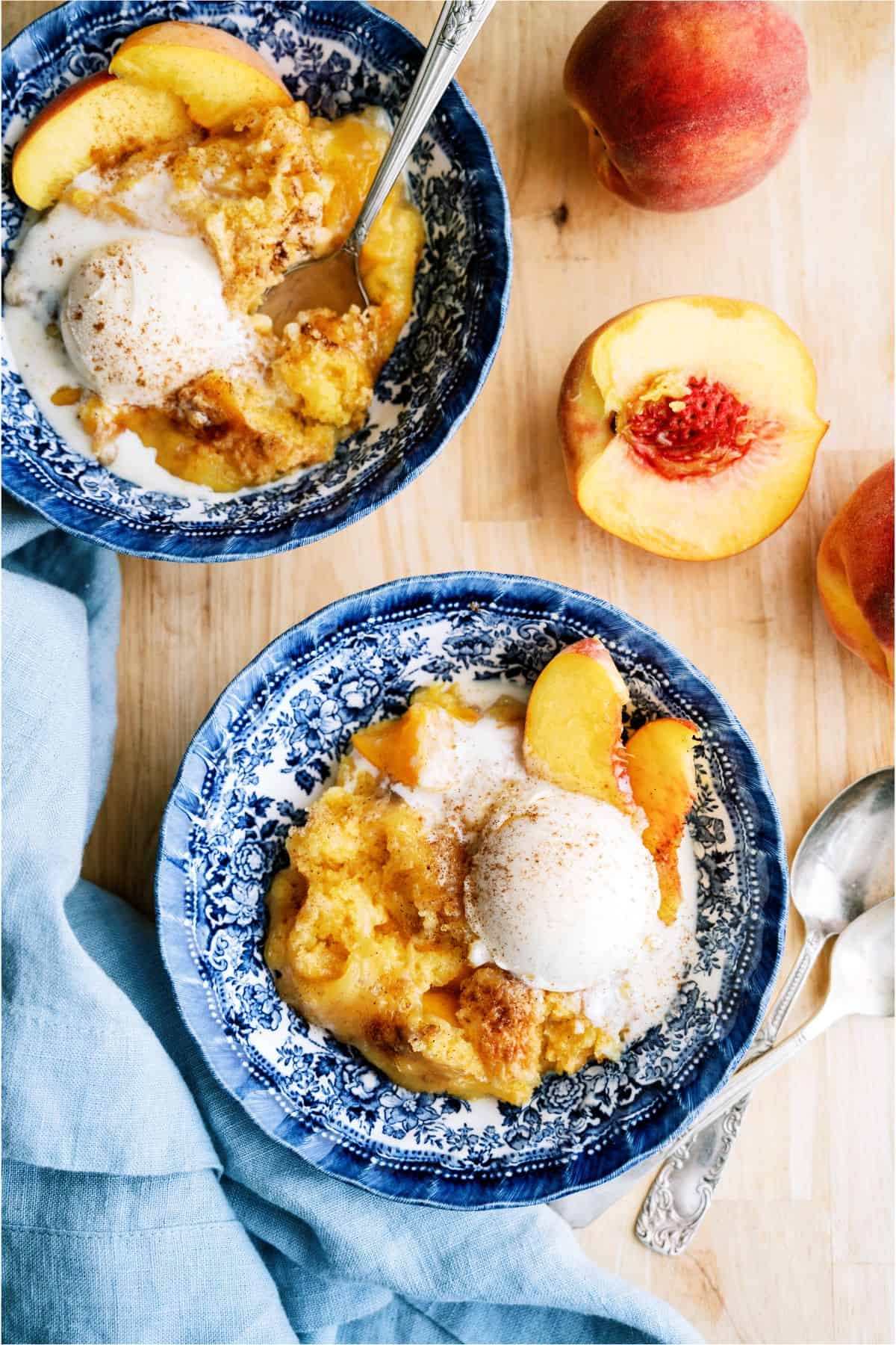 2 bowls of Peach Cobbler Dump Cake (4 Ingredients) topped with ice cream