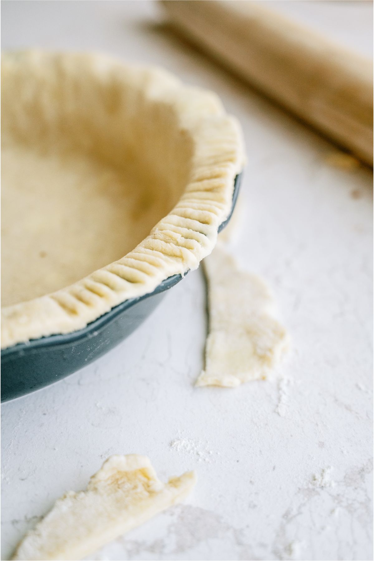 Uncooked Pie Crust spread over a pie plate.