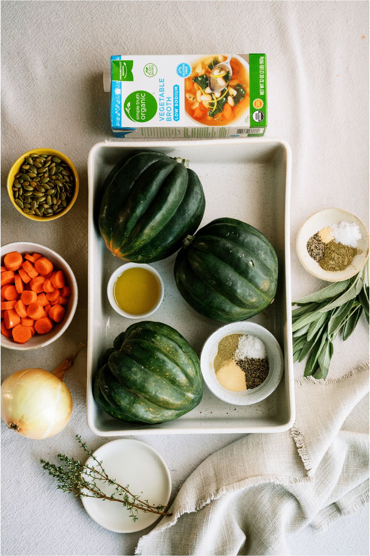 Ingredients needed to make Acorn Squash Soup laid out on a countertop.