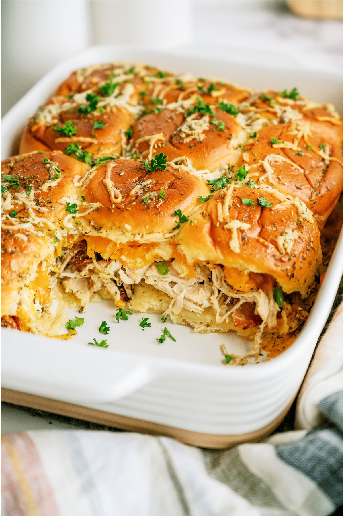 A pan of Crack Chicken Sliders with two sliders missing.