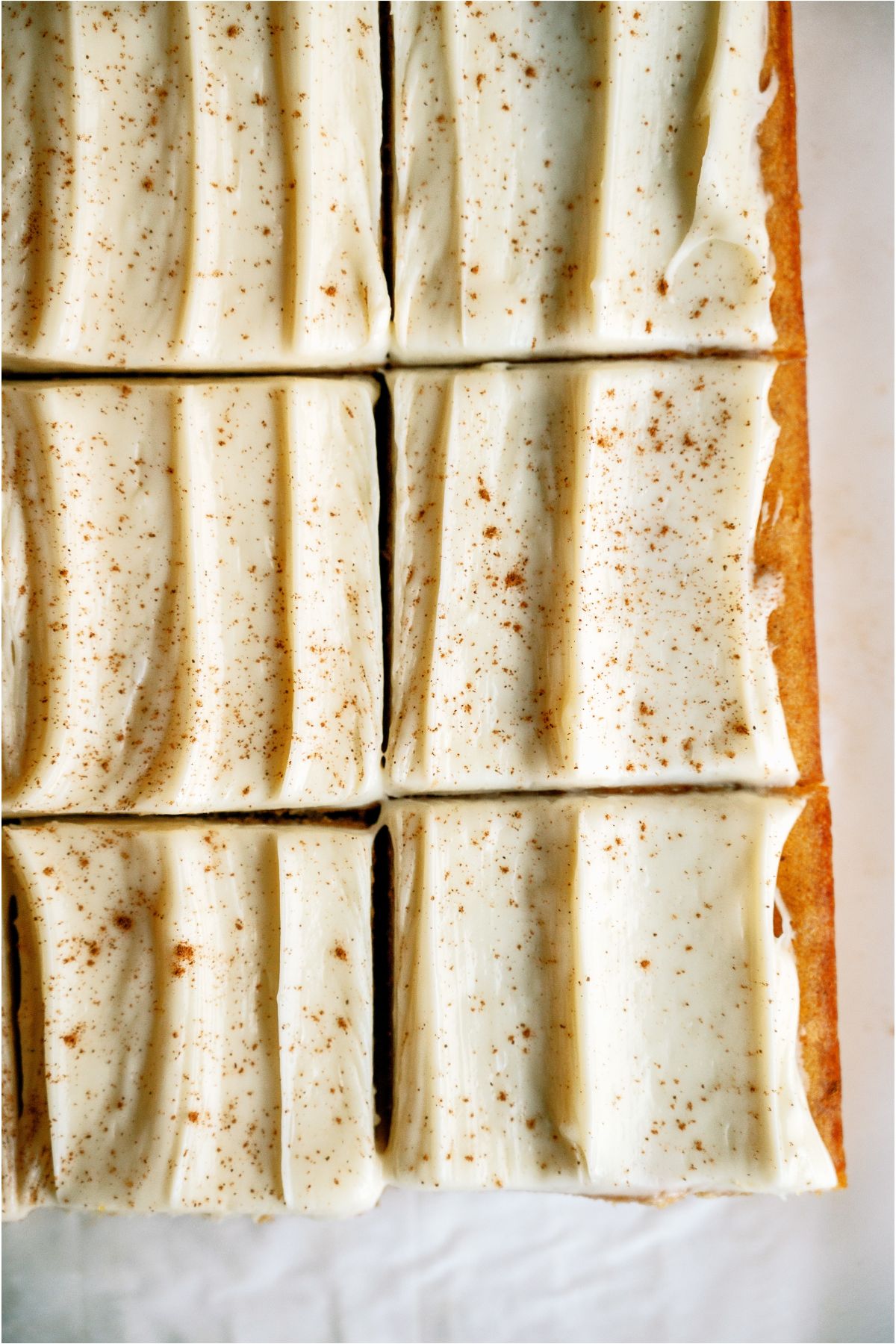 Top view of Pumpkin Bars topped with cream cheese frosting and cut into squares.