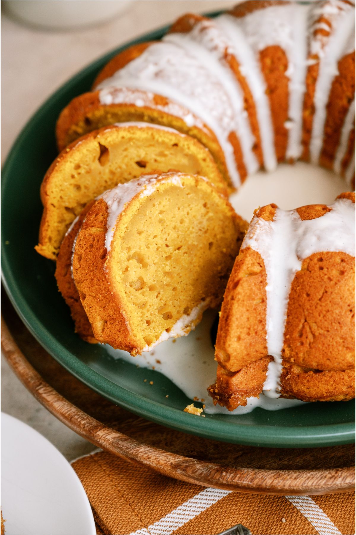 Close up of Pumpkin Bundt Cake with cream cheese glaze sliced.