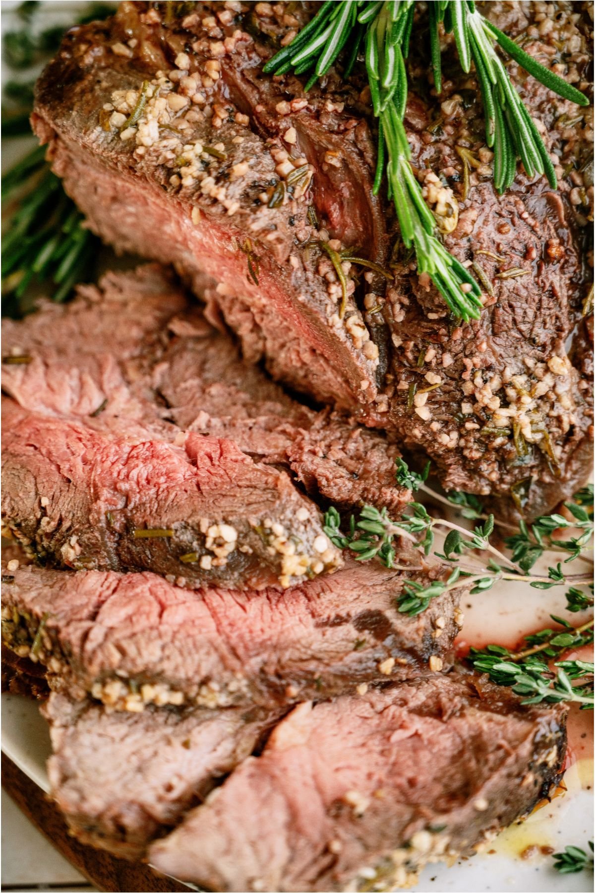 Top view of slices of Garlic Butter Beef Roast on a serving plate.