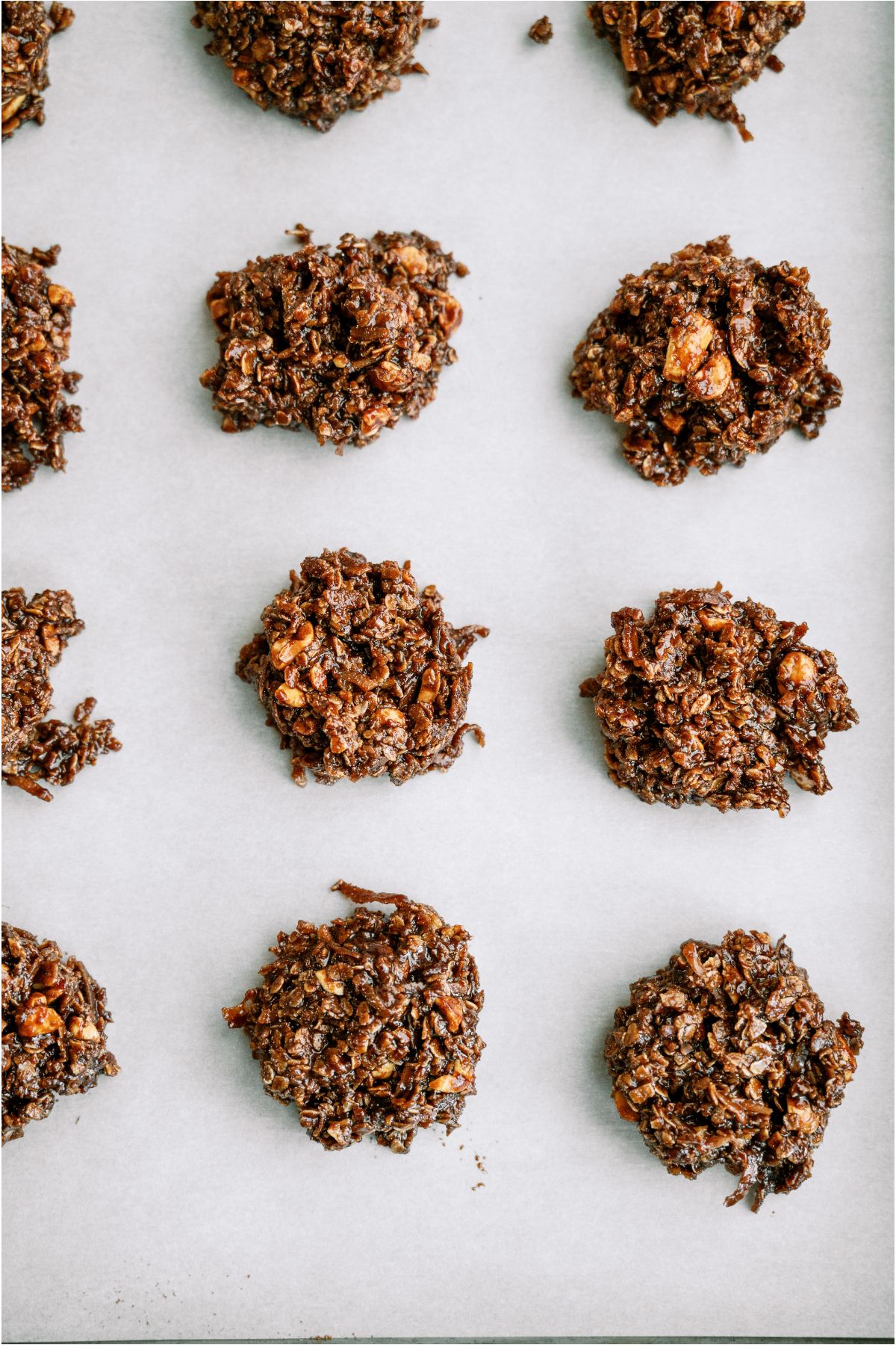 Top view of Haystack Cookies in rows on a baking sheet lined with parchment paper.