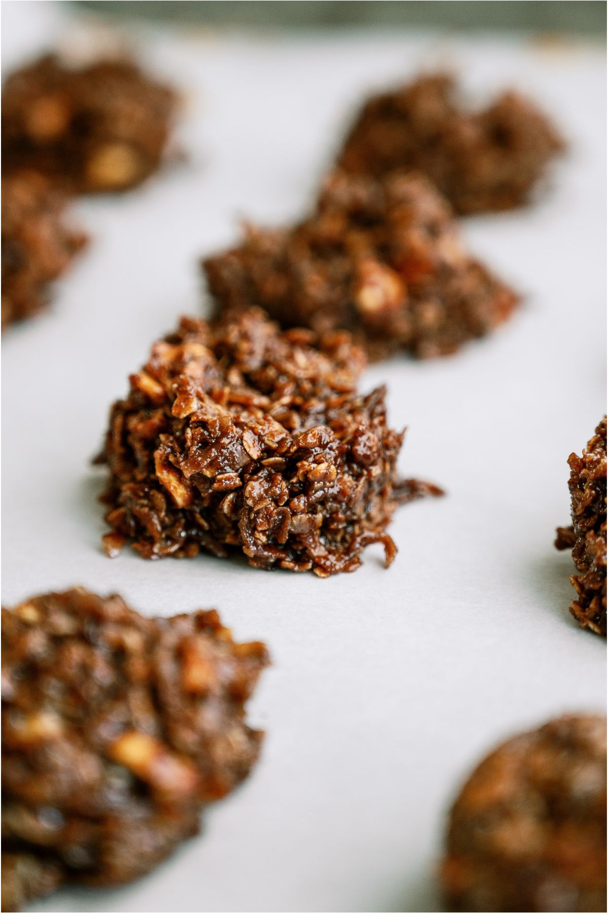 Front view of Haystack Cookies lined up on a baking sheet lined with parchment paper.