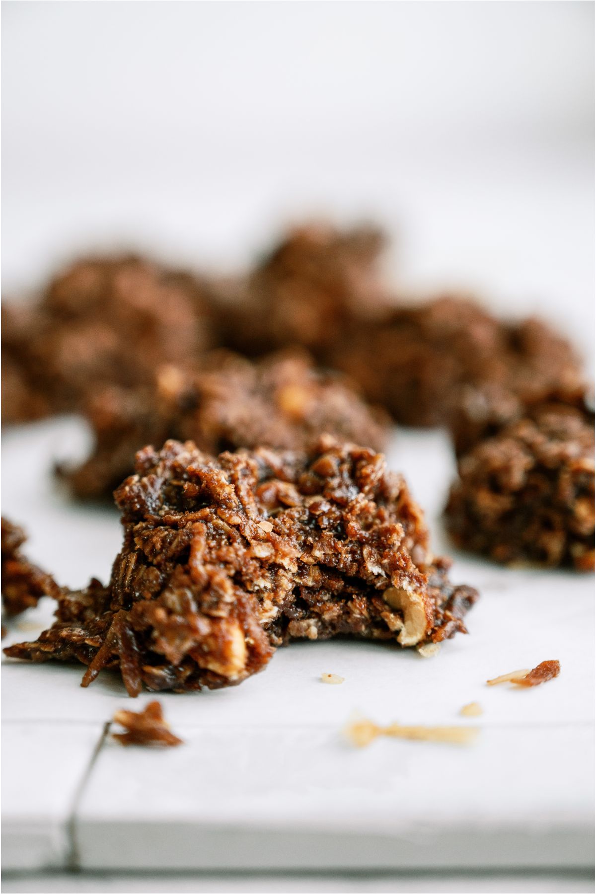 Close up of a Haystack Cookies on a baking sheet lined with parchment paper with a bite missing out of the cookie.