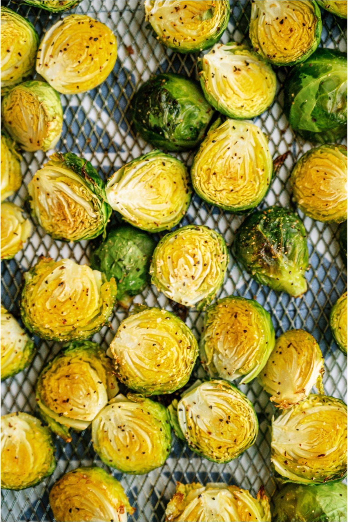 Crispy Air Fryer Brussel Sprouts on top of a mesh rack.