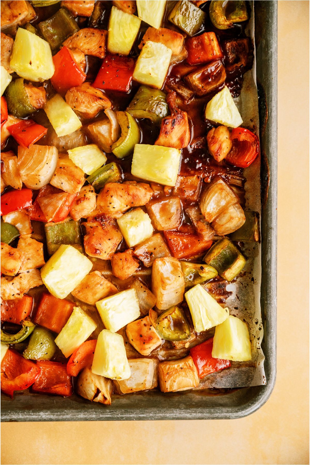 Sheet Pan Hawaiian Chicken on a sheet pan lined with parchment paper.