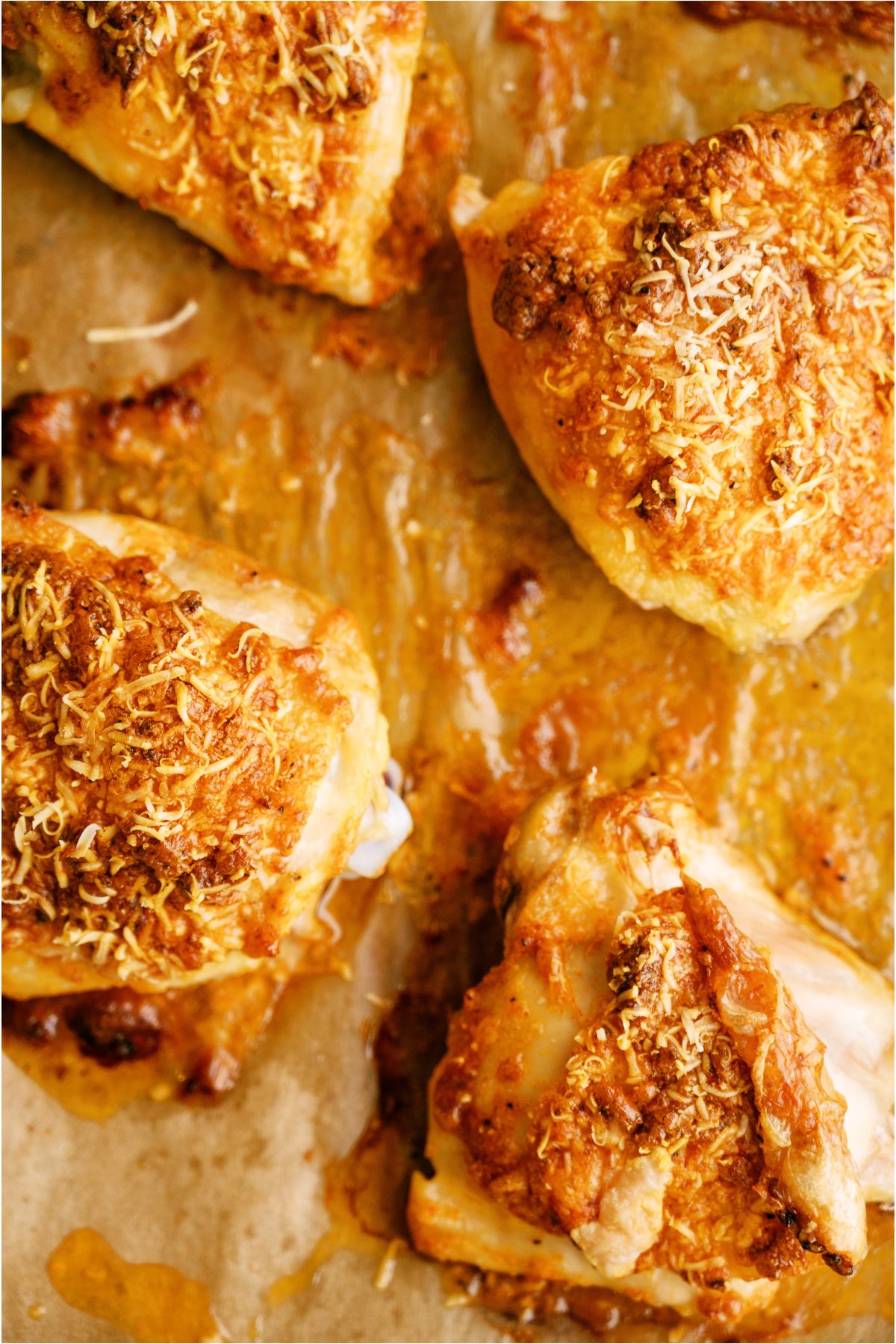 Top view of Creamy Garlic Parmesan Chicken on a baking sheet lined with parchment paper.