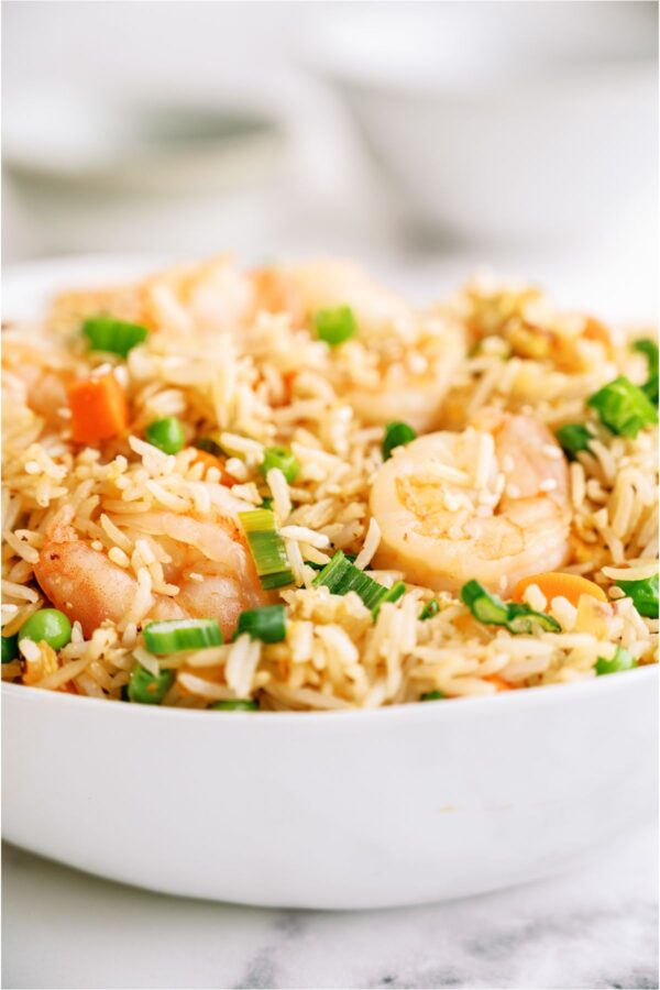 A white bowl filled with Shrimp Fried Rice.