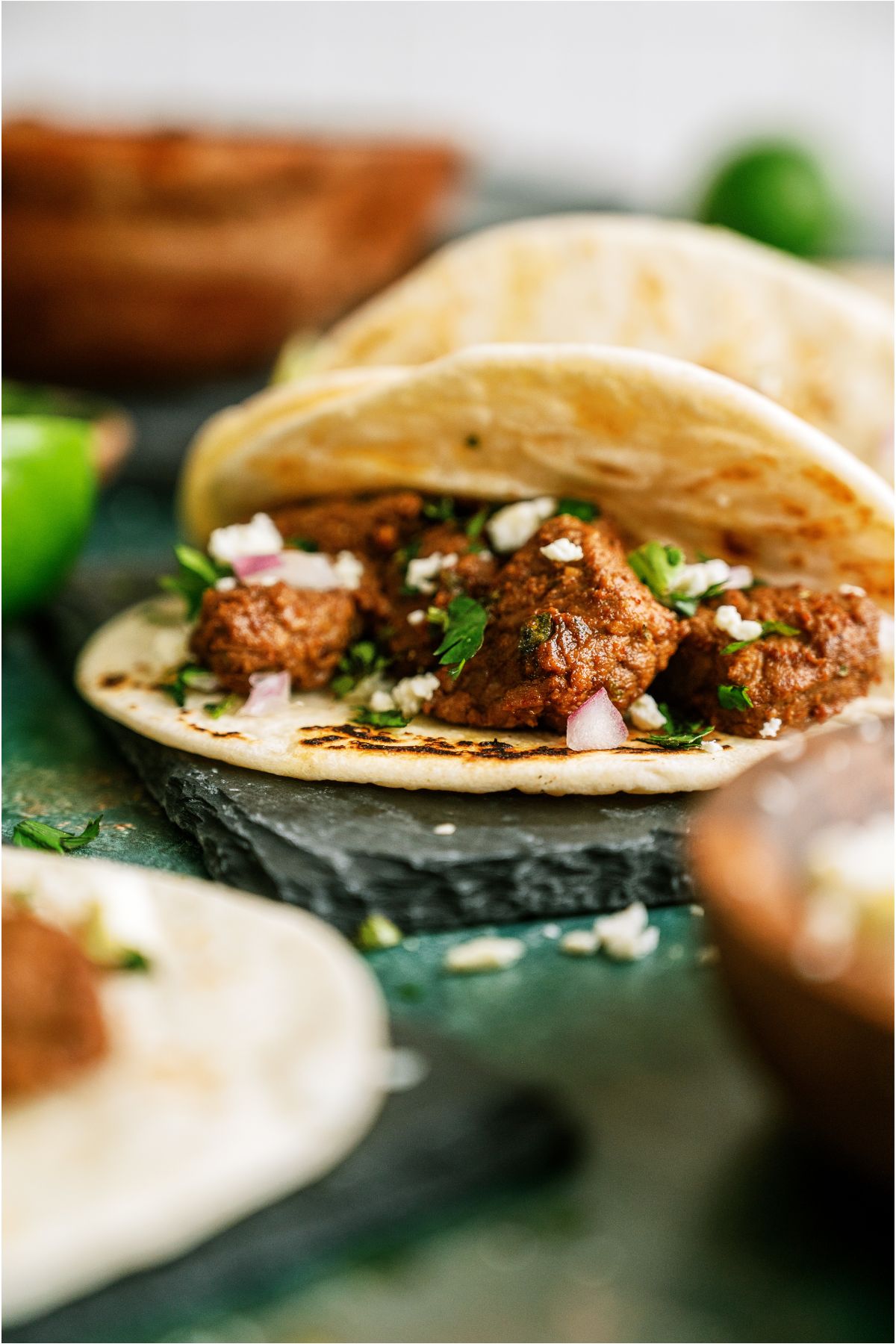 A close up view of a Street Tacos (Carne Asada) folded in half.